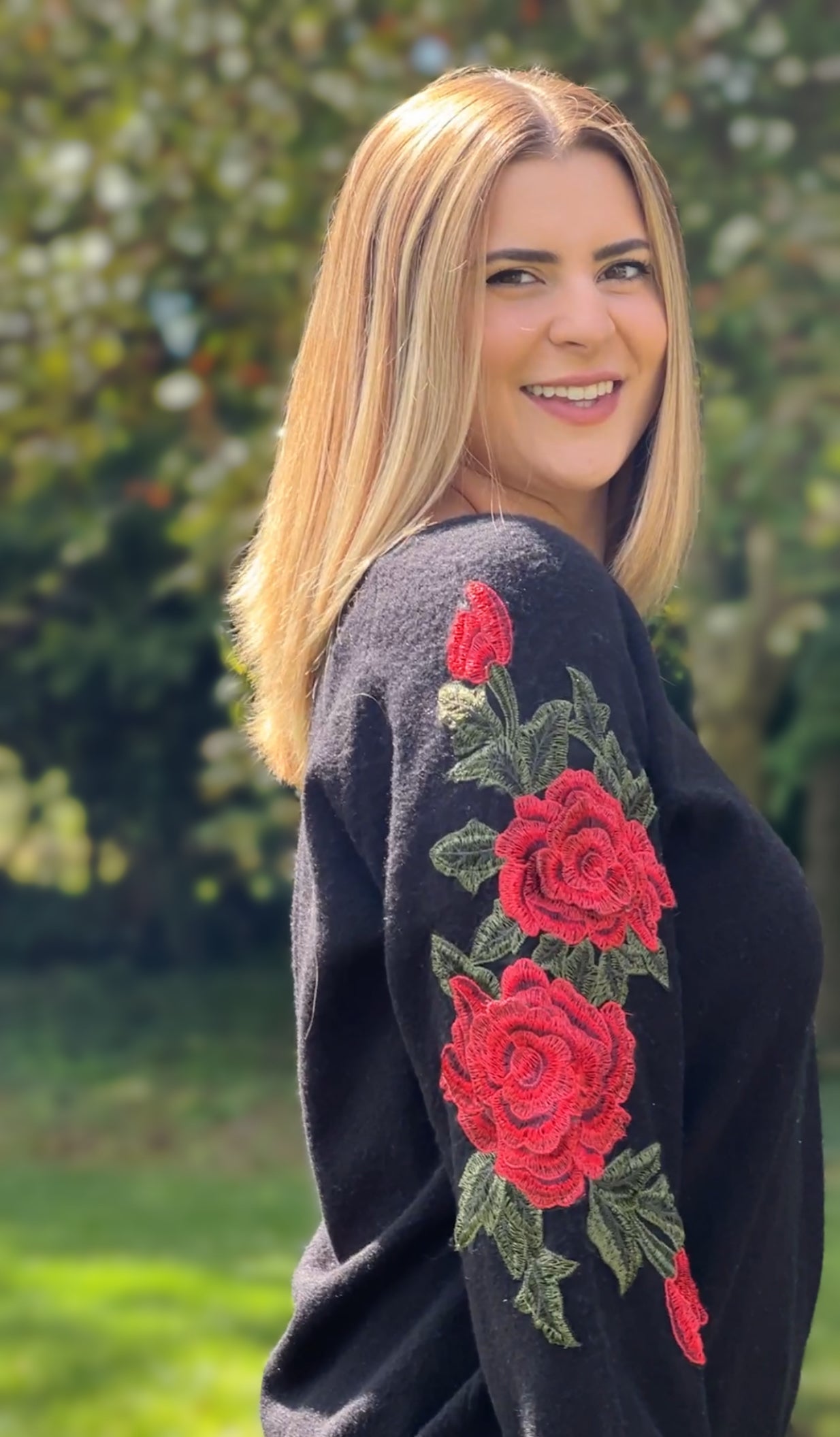 Black sweater shop with red roses